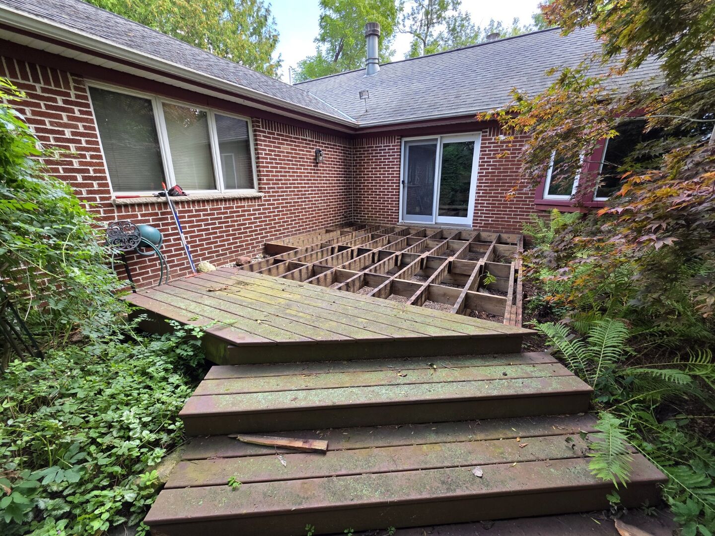 Deck surface partially removed, exposing the supporting joists