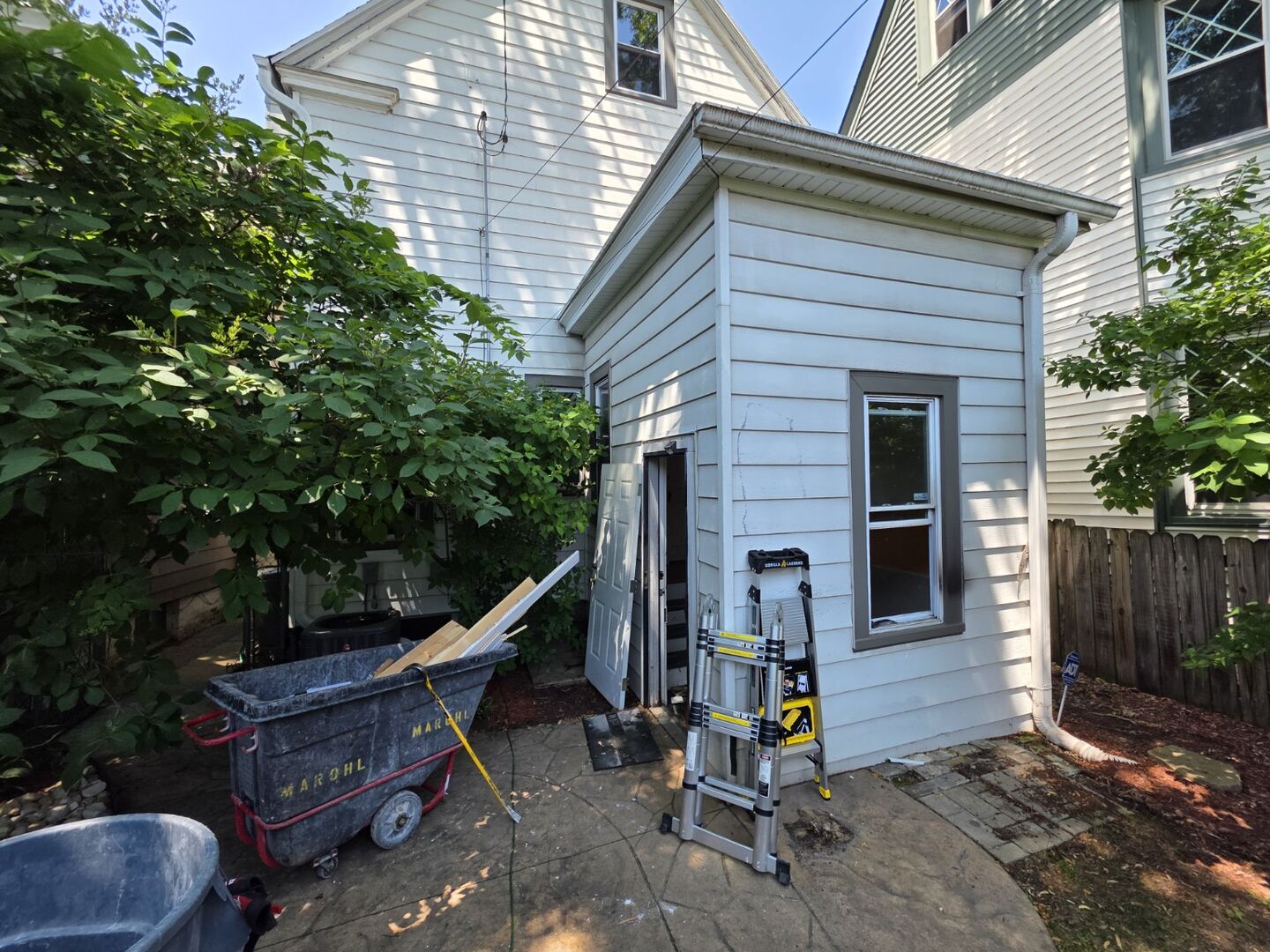 Residential structure and work area photographed during demolition preparation
