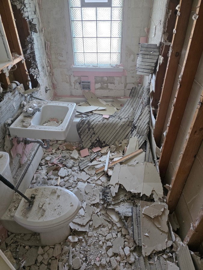 Bathroom demolition with tile and fixtures torn out