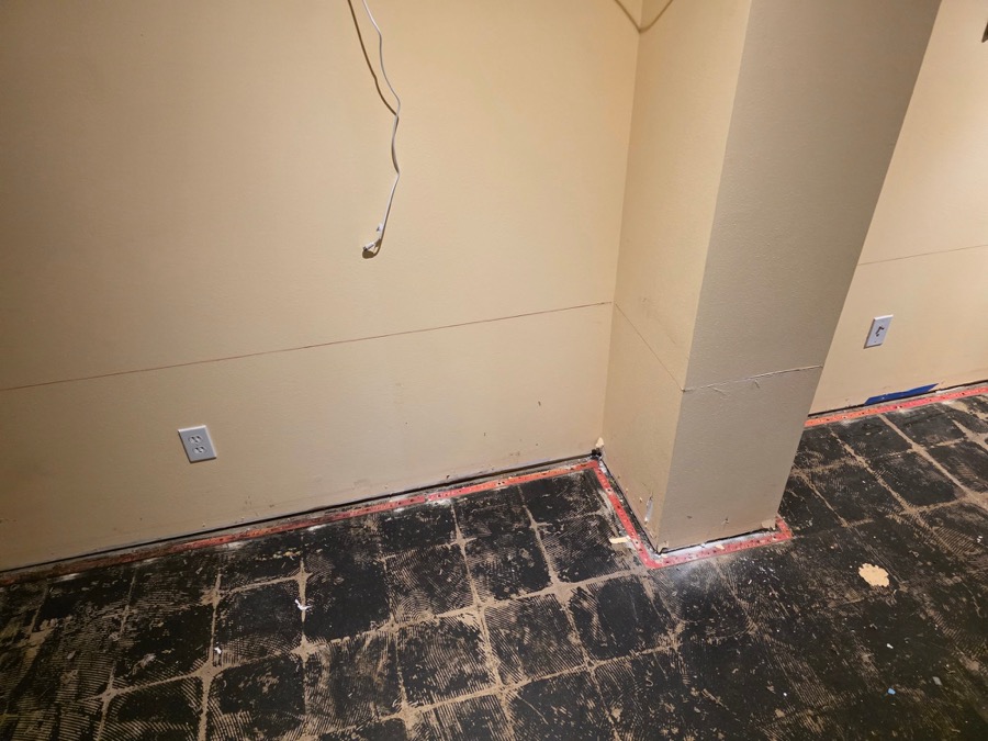Tile and adhesive removed down to the subfloor